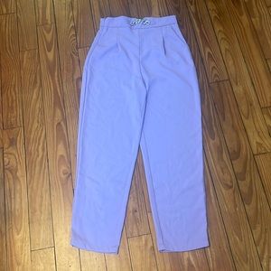 High waisted purple trousers with metal buckle detail.